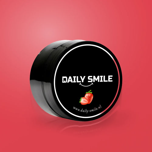 Daily Smile actieve kool tandpoeder Aardbei op een rode achtergrond