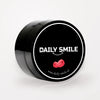 Daily Smile actieve kool tandpoeder Framboos, zwart potje op een lichte studioachtergrond