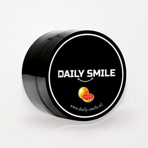 Daily Smile actieve kool tandpoeder Grapefruit, zwart potje op een lichte studioachtergrond
